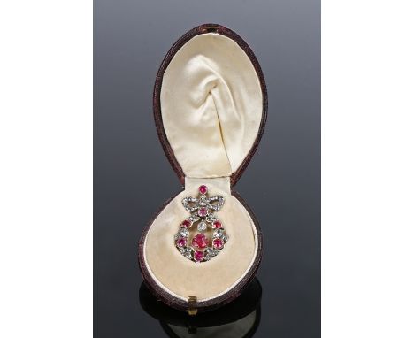 Fine ruby and diamond set pendant, with a central hanging ruby and diamond and ruby surround, a ribbon above, the diamonds at