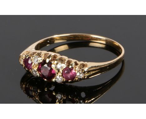 18 carat gold ruby and diamond ring, with three rubies and six diamonds to the head, ring size Q