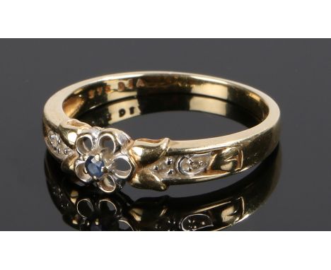 9 carat gold sapphire and diamond set ring, with a central sapphire and flower design with diamonds to the shoulders, ring si