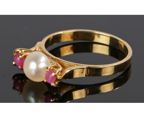 Pearl and ruby set ring, with a central pearl flanked by rubies to the gold shank, ring size N