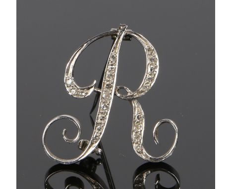 Diamond set brooch, the initial R set with round cut diamonds to white metal, 26mm high