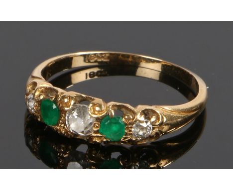 18 carat gold emerald and diamond set ring, with two emeralds and three diamonds to the head, ring size M 1/2