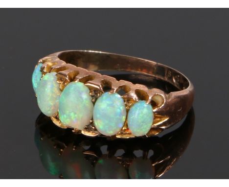 9 carat gold opal set ring, with five cabochon cut opals set to the shank, ring size L