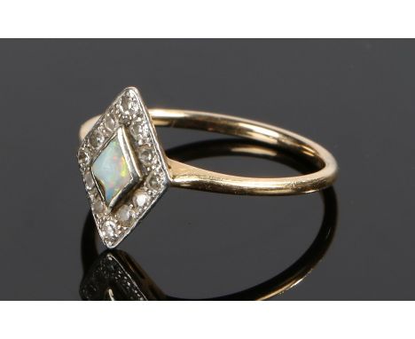 Opal and diamond set ring, the central opal with a diamond surround in a diamond shaped head, ring size N