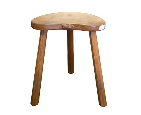 Workshop of Robert "Mouseman" Thompson - an oak three legged stool with kidney shaped top, and signature carved mouse to side