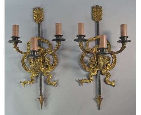 A set of four Empire style wall lights, 20th century, with ribbon tied and arrow back plates, issuing three scrolling arms wi