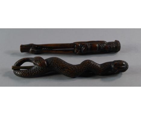 A Japanese hardwood pipe case, late 19th/early 20th century, in the form of a snake, with a pipe mounted with bronze fittings