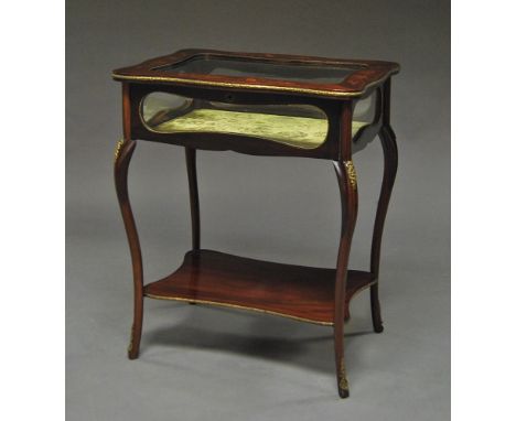 An Edwardian mahogany and gilt metal mounted table vitrine, shaped rectangular top with glazed top and sides, above shaped re