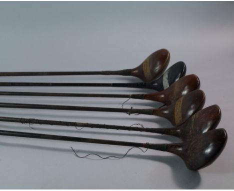A large collection of golf clubs, 20th century, many with wooden shafts, various makers noted to include Campbell and Co, A. 
