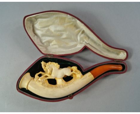 An Austrian or German meerschaum pipe, late 19th/20th century, carved to the top with running horses, with amber mouth piece 