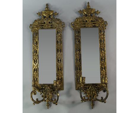 A pair of Victorian pierced plated metal girandoles, with rectangular bevelled mirrors, crested by urn and fish motifs, with 