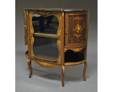 An Edwardian mahogany and gilt metal mounted cabinet vitrine, central glazed door flanked by two shaped cupboard doors, raise