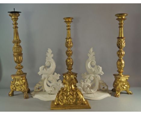 A pair of gilt pricket candlesticks, of Spanish style, with foliate columns on tripod paw feet, 55cm high, together with a si