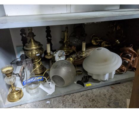 A selection of lighting to include brass effect chandeliers porch and storm lanterns, some with glass shades, along with a pa
