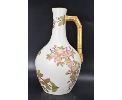 A late 19th century Royal Worcester blush ivory jug, date mark for 1888, shouldered form with bamboo moulded handle, painted 