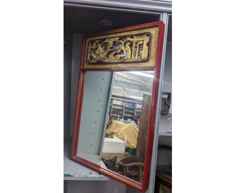 A mid 20th century Chinese red lacquered wall mirror having a pierced gilt scene above 72h x 46w, together with a mid century