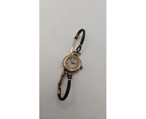 A 9ct gold ladies manual wind wristwatch A/F, on a fabric bracelet and a clasp, total weight, 17/6g, Location:CAB 1 
