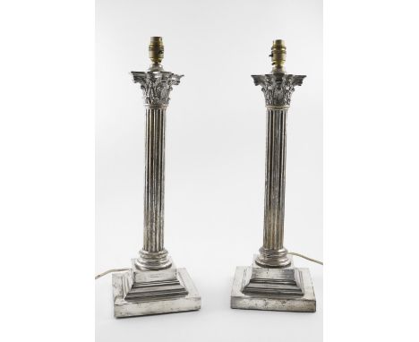 A PAIR OF LARGE SILVER PLATED TABLE LAMPS. in the form of Corinthian Columns, each initialled "G.S" on the square bases, 22" 