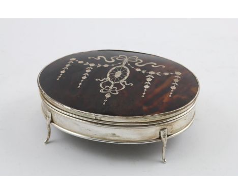 A GEORGE V OVAL DRESSING TABLE BOX. on four legs with an inlaid tortoiseshell cover and a silk-lined interior, by E.S Barnsle