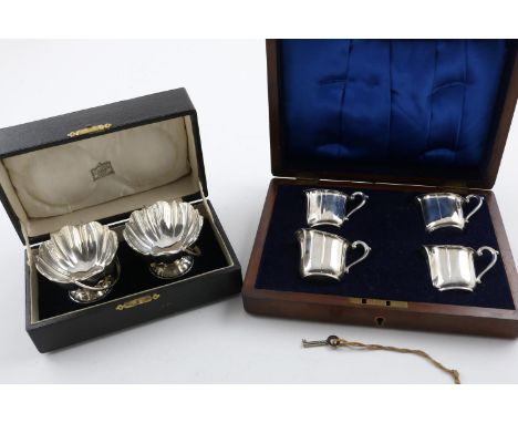 AN EDWARDIAN CASED PAIR OF BONBON DISHES. with fluted bodies and swing handles on a domed circular foot, in original fitted c