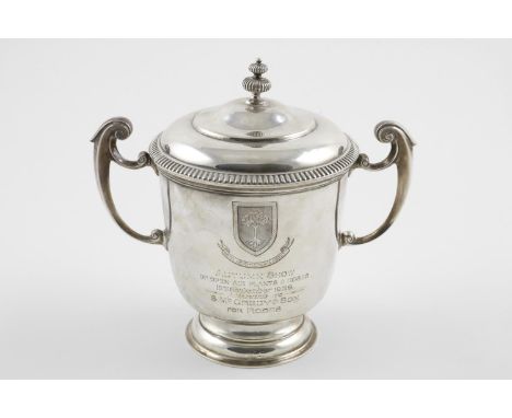 A GEORGE V TWO-HANDLED CUP AND COVER. the domed cover with a fluted finial, the body with  scroll handles, on a circular foot