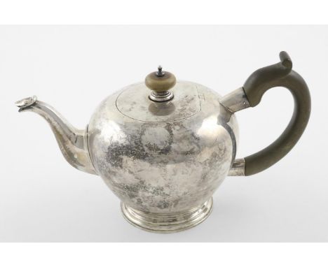 A MODERN BULLET TEAPOT. with a wooden C-scroll handle, a turned finial, and a circular foot,  by Harrods Ltd, London 1965; 9.