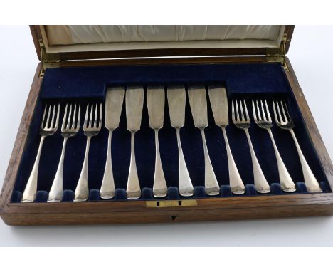A GEORGE V CASED SET OF FISH KNIVES &amp; FORKS. Old English Pattern, contained in original oak case, by James Dixon &amp; So