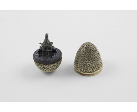 BY STUART DEVLIN:-. a late 20th century silvergilt "surprise" egg, with a textured surface, opening to reveal a clown or joke