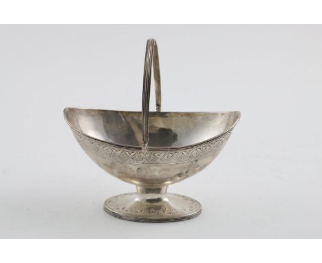 A GEORGE III BOAT-SHAPED SUGAR BASKET. with a swing handle, reeded borders and a bright-engraved frieze around the foot and b