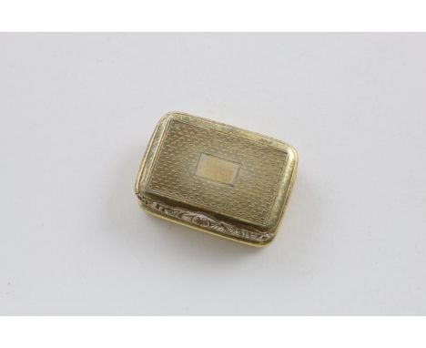 A GEORGE III SILVERGILT VINAIGRETTE. oblong, with engine-turning, reeded sides and a raised thumbpiece, vacant cartouche, by 