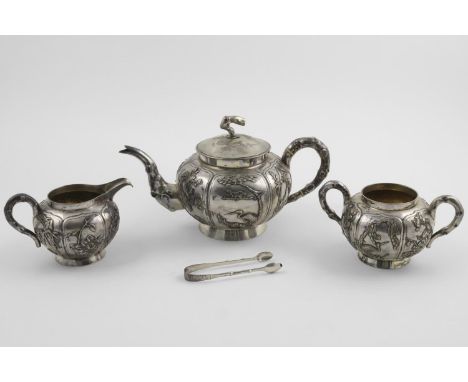 A LATE 19TH/EARLY 20TH CENTURY CHINESE FOUR PIECE TEA SET. of circular form with applied decoration of fruits, birds, prunes,