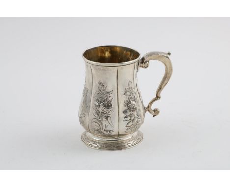 A GEORGE II MUG. of lobed baluster form, with a scroll handle, later foliate decoration and a  circular foot, inscribed, gilt