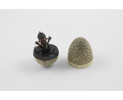 BY STUART DEVLIN:-. a late 20th century silvergilt "surprise" egg, with a textured surface, opening to reveal a Jack in the b