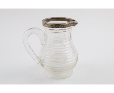 A GEORGE V MOUNTED CUT GLASS WATER JUG. of baluster form, with a C-scroll handle, maker's mark worn, London 1910; 6.75" (17cm