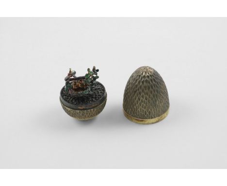 BY STUART DEVLIN:-. a late 20th century silvergilt "surprise" egg, with a textured surface, opening to reveal chicks in a nes