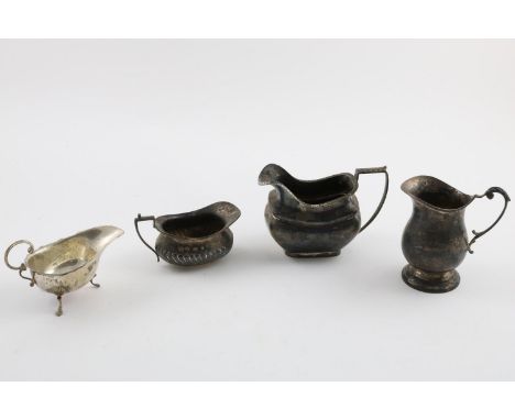 FOUR MILK JUGS:-. an Edwardian example, by Boardman, Glossop &amp; Co Ltd, Birmingham 1904, one by James William Benson, Lond