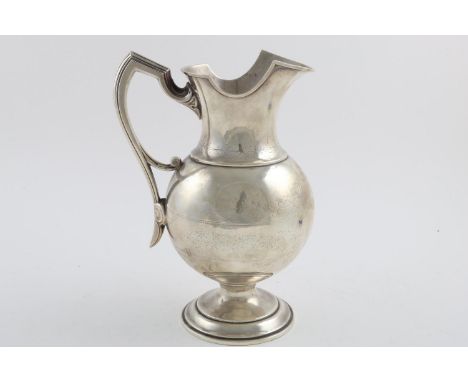 A LATE 19TH/EARLY 20TH CENTURY NORTH AMERICAN PITCHER. with a helmet shaped rim, angular handle and circular foot, decorated 