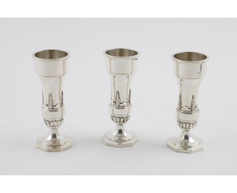 A SET OF THREE ELIZABETH II ART DECO REVIVAL VASES. by Walker &amp; Hall, Sheffield 1964; 4.9" (12.5 cms) high; 10.1oz (3).  
