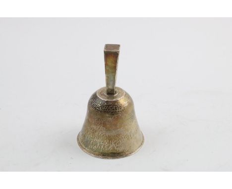 A GEORGE V HANDMADE BELL. with a square tapering handle, the body with a hammered finish all over, by Charles Godfrey Langdon