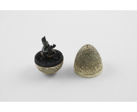BY STUART DEVLIN:-. a late 20th century silvergilt "surprise" egg, with a textured surface, opening to reveal a kangaroo with