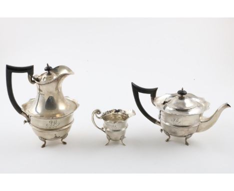A GEORGE V MATCHING HOT WATER POT, TEA POT &amp; MILK JUG. with wavy rims, and hoof feet, all initialled and inscribed, by Wi