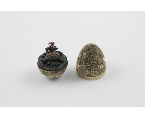 BY STUART DEVLIN:-. a late 20th century silvergilt "surprise" egg, with a textured surface, opening to reveal a tortoise amon