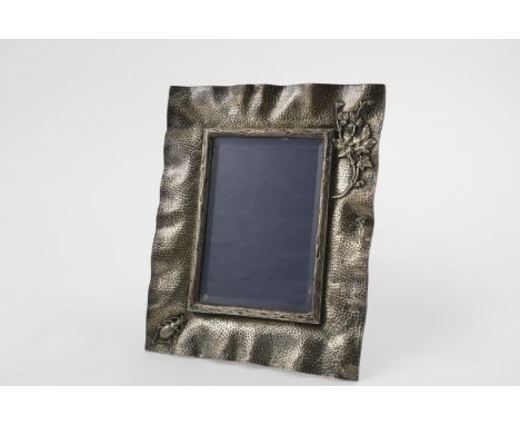 A VICTORIAN NATURALISTIC PHOTOGRAPH FRAME. with a wavy edge, resembling a rectangular piece of cloth, a bark-textured border 
