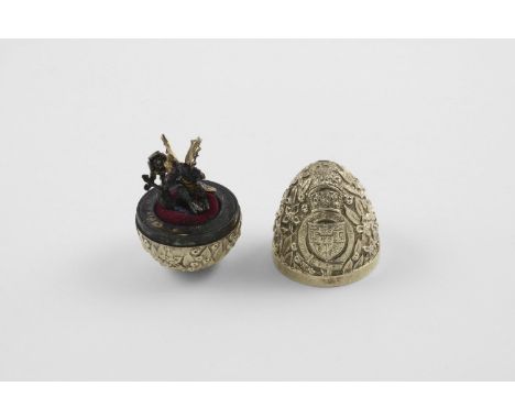 BY STUART DEVLIN:-. a late 20th century silvergilt commemorative  "surprise" egg, with a textured surface in relief with flow