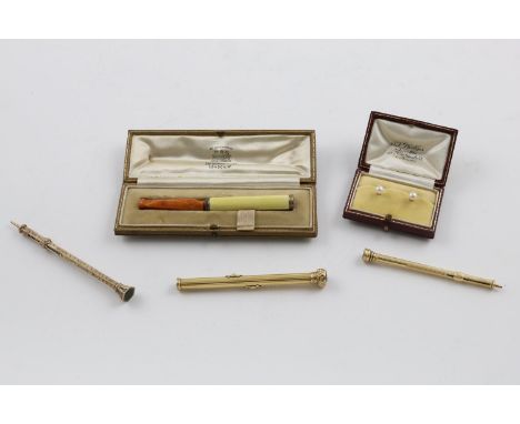 A MIXED LOT:-. a gold mounted amber and enamel cheroot holder (A/F), a late 19th/early 20th century gold cased pen/pencil in 