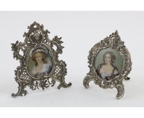 TWO LATE 19TH/EARLY 20TH CENTURY GERMAN PHOTOGRAPH FRAMES. both decorated in relief  with floral scrolls and cherubs, easel b
