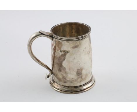 A GEORGE V MUG. with a moulded rim, S-scroll handle and a spreading circular foot,  inscribed, by Atkin Brothers, Sheffield 1