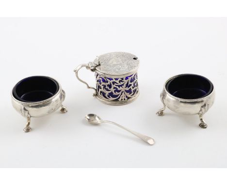 A PAIR OF GEORGE III CIRCULAR SALTS. on three hoof feet and blue glass liners, crested, by Hester Bateman, London 1777, toget