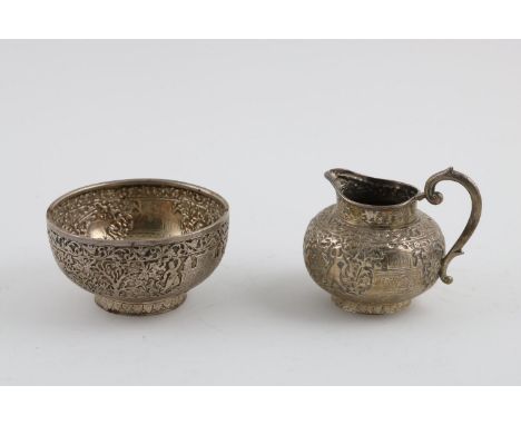 A LATE 19TH/EARLY 20TH CENTURY INDIAN SUGAR BOWL AND MILK JUG. both chased around the bodies with figures, animals and buildi