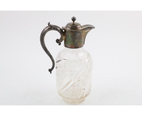 AN EDWARDIAN MOUNTED CUT GLASS CLARET JUG. with a C-scroll handle and a ball finial, inscribed, by Barker Brothers, Birmingha